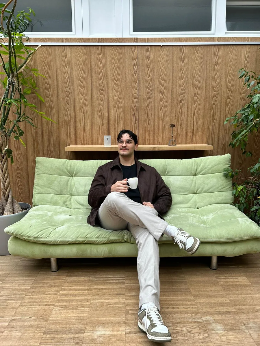 Danijel Balog, founder of FragonForge, sitting on a green sofa with an espresso and no laptop in sight